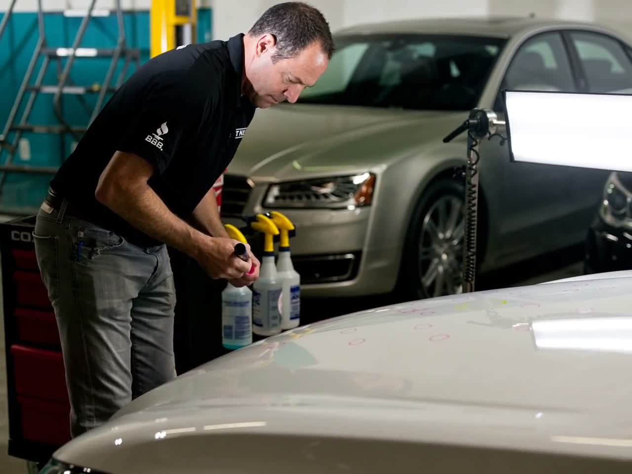 A vehicle hood undergoing a professional damage inspection